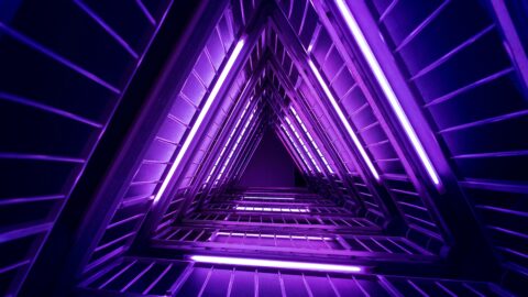 Neon purple triangles extend into the distance in futuristic image.